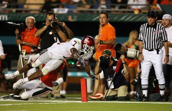 FORT LAUDERDALE, FL - OCTOBER 03: Running back DeMarco Murray #7 of the Oklahoma Sooners dives for the end-zone but comes up short as he is taken out of bounds by defensive back Vaughn Telemaque #7 of the Miami Hurricanes at Land Shark Stadium on October 