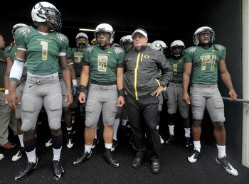 EUGENE, OR - SEPTEMBER 19: Darron Thomas #1, Jeremiah Masoli #8, head coach Chip Kelly and Javes Lewis #14 of the Oregon Ducks wait in the tunnel to be introduced before the start of the game against the Utah Utes at Autzen Stadium on September 19, 2009 i