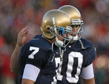 SOUTH BEND, IN - OCTOBER 17: Jimmy Clausen #7 of the Notre Dame Fighting Irish is consoled by teammate Dayne Crist #10 during a game against the USC Trojans at Notre Dame Stadium on October 17, 2009 in South Bend, Indiana. USC defeated Notre Dame 34-27. (