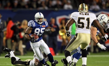 MIAMI GARDENS, FL - FEBRUARY 07: Pierre Garcon #85 of the Indianapolis Colts runs with the ball after a catch against Jonathan Vilma #51 of the New Orleans Saints during Super Bowl XLIV on February 7, 2010 at Sun Life Stadium in Miami Gardens, Florida.  (