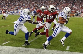 GLENDALE, AZ - SEPTEMBER 27:  Donald Brown #31 of the Indianapolis Colts steps out of bounds as he runs ahead of teammate Pierre Garcon #85,  Dominique Rodgers-Cromartie #29 and Antrel Rolle #21 of the Arizona Cardinals during the game at University of Ph