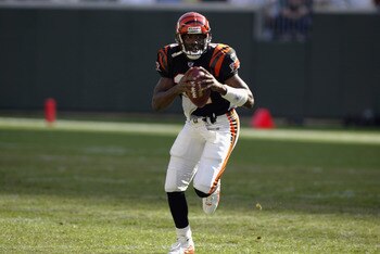 CINCINNATI - SEPTEMBER 29:  Quarterback Akili Smith #11 of the Cincinnati Bengals runs with the ball during the NFL game against the Tampa Bay Buccaneers on September 29, 2002 at Paul Brown Stadium in Cincinnati, Ohio.  The Buccaneers won 35-7. (Photo by 
