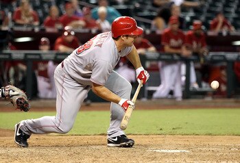 PHOENIX - AUGUST 18:  Chris Heisey #28 of the Cincinnati Reds lays down a RBI bunt single during the ninth inning of the Major League Baseball game  the Arizona Diamondbacks at Chase Field on August 18, 2010 in Phoenix, Arizona.  (Photo by Christian Peter