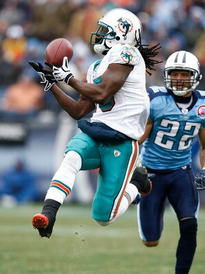 NASHVILLE, TN - DECEMBER 20: Davone Bess #15 of the Miami Dolphins catches a pass behind Vincent Fuller #22 of the Tennessee Titans at LP Field on December 20, 2009 in Nashville, Tennessee. The Titans defeated the Dolphins 27-24 in overtime. (Photo by Joe