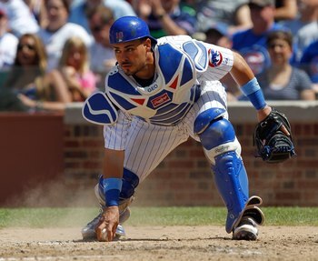 CHICAGO - JUNE 20: Geovany Soto #18 of the Chicago Cubs picks up the ball against the Los Angeles Angels of Anaheim at Wrigley Field on June 20, 2010 in Chicago, Illinois. The Cubs defeated the Angels 12-1. (Photo by Jonathan Daniel/Getty Images)