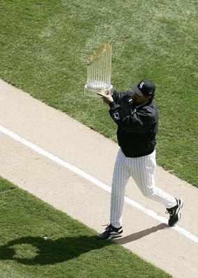 CHICAGO - APRIL 05:  Manager Ozzie Guillen of the Chicago White Sox holds the 2005 World Series Championship trophy for fans before a game against the Cleveland Indians on April 5, 2006 at U.S. Cellular Field in Chicago, Illinois. (Photo by Jonathan Danie
