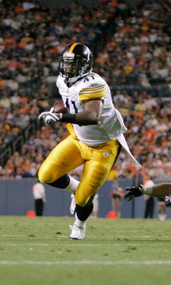 DENVER - AUGUST 29: Running back Jonathan Dwyer #41 of the Pittsburgh Steelers avoids a diving tackle by safety Kyle McCarthy #34 of the Denver Broncos and scores a touchdown in the fourth quarter at INVESCO Field at Mile High on August 29, 2010 in Denver