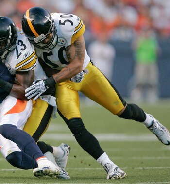 DENVER - AUGUST 29:  Wide receiver Brandon Lloyd #84 of the Denver Broncos is brought down by cornerback Keenan Lewis #23 and linebacker Larry Foote #50 of the Pittsburgh Steelers in the second quarter at INVESCO Field at Mile High on August 29, 2010 in D
