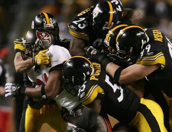PITTSBURGH - DECEMBER 3:   Alex Smith #81 of the Tampa Bay Buccaneers is tackled by the Pittsburgh Steelers defence at Heinz Field on December 3, 2006 in Pittsburgh, Pennsylvania.  (Photo by Nick Laham/Getty Images)