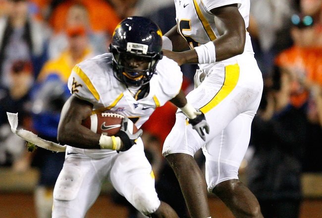 AUBURN, AL - SEPTEMBER 19:  Quarterback Jarrett Brown #16 and Noel Devine #7 of the West Virginia Mountaineers against the Auburn Tigers at Jordan-Hare Stadium on September 19, 2009 in Auburn, Alabama.  (Photo by Kevin C. Cox/Getty Images)
