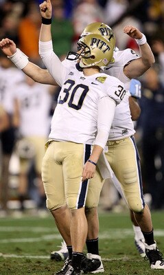 CHARLOTTE, NC - DECEMBER 26:  Dan Hutchins #30 of the Pittsburgh Panthers celebrates with teammate Andrew Janocko #4 after making a game-winning field goal to defeat the North Carolina Tar Heels 19-17 during their game on December 26, 2009 in Charlotte, N