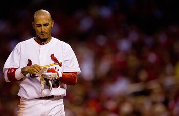 ST. LOUIS - JULY 20: Felipe Lopez #3 of the St. Louis Cardinals removes his batting gloves after striking out against the Philadelphia Phillies at Busch Stadium on July 20, 2010 in St. Louis, Missouri.  (Photo by Dilip Vishwanat/Getty Images)