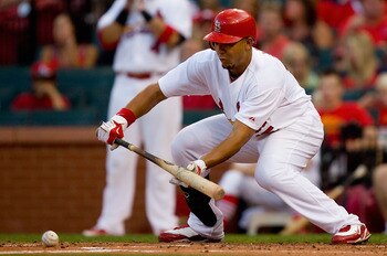 ST. LOUIS - AUGUST 21: Jon Jay #15 of the St. Louis Cardinals bunts against the San Francisco Giants at Busch Stadium on August 21, 2010 in St. Louis, Missouri.  (Photo by Dilip Vishwanat/Getty Images)