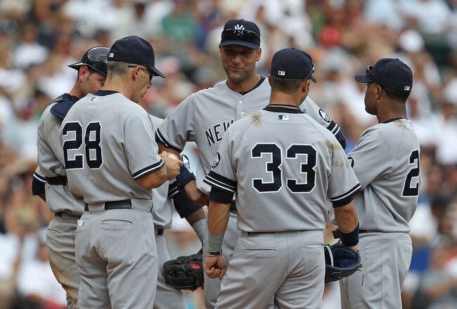 CHICAGO - AUGUST 29: Manager Joe Girardi #28 of the New York Yankees talks with (L-R) Francisco Cervelli #29, Derek Jeter #2, Nick Swisher #33 and Robinson Cano #24 at the mound during a pitching change against the Chicago White Sox at U.S. Cellular Field
