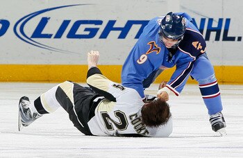 ATLANTA - APRIL 10:  Matt Cooke #24 of the Pittsburgh Penguins is knocked out by this right-handed punch from Evander Kane #9 of the Atlanta Thrashers at Philips Arena on April 10, 2010 in Atlanta, Georgia.  (Photo by Kevin C. Cox/Getty Images)