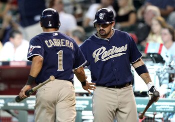 PHOENIX - SEPTEMBER 01:  Adrian Gonzalez #23 of the San Diego Padres high fives teammate Everth Cabrera #1 after he scored a run against the Arizona Diamondbacks during the Major League Baseball game at Chase Field on September 1, 2010 in Phoenix, Arizona