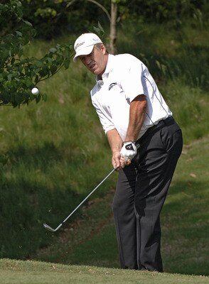 UNITED STATES - APRIL 27:  John Elway chips into the 15th green at the Cliffs at Keowee Vineyards during the first round of the Nationwide Tour BMW Charity Pro-Am, April 27, 2006 in Greenville, South Carolina.  (Photo by Al Messerschmidt/Getty Images)