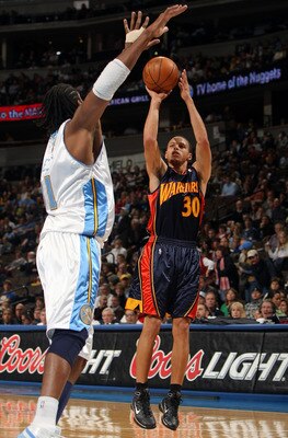 DENVER - JANUARY 05:  Stephen Curry #30 of the Golden State Warriors gets off a shot against Nene #31 of the Denver Nuggets at the Pepsi Center on January 5, 2010 in Denver, Colorado. NOTE TO USER: User expressly acknowledges and agrees that, by downloadi