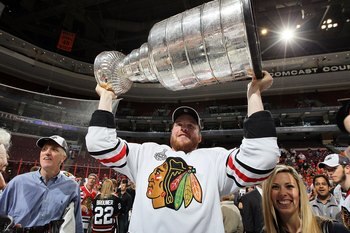 PHILADELPHIA - JUNE 09:  Bryan Bickell #29 of the Chicago Blackhawks hoists the Stanley Cup after teammate Patrick Kane scored the game-winning goal in overtime to defeat the Philadelphia Flyers 4-3 and win the Stanley Cup in Game Six of the 2010 NHL Stan