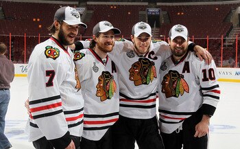 PHILADELPHIA - JUNE 09:  Brent Seabrook #7, Duncan Keith #2, Jonathan Toews #19 and Patrick Sharp #10 of the Chicago Blackhawks celebrate after the Blackhawks defeated the Philadelphia Flyers 4-3 in overtime to win the Stanley Cup in Game Six of the 2010 