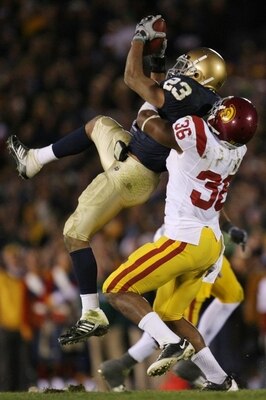 Tate goes up to get a pass from Jimmy Clausen in a game against USC