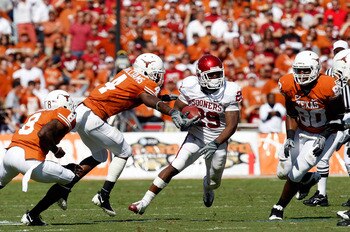 DALLAS - OCTOBER 17:  Running back Chris Brown #29 of the Oklahoma Sooners runs the ball past Aaron Williams #4 of the Texas Longhorns at Cotton Bowl on October 17, 2009 in Dallas, Texas.  (Photo by Ronald Martinez/Getty Images)