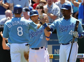 KANSAS CITY, MO - AUGUST 15:  Willie Bloomquist #8 of the Kansas City Royals is congratulated by Alex Gordon #4 and Wilson Betemit #46 after scoring the game's only run during the first inning of the game against the New York Yankees on August 15, 2010 at