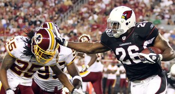 GLENDALE, AZ - SEPTEMBER 02:  Runningback Beanie Wells #26 of the Arizona Cardinals rushes the football against Chris Wilson #95 and Kevin Barnes #25 of the Washington Redskins during the first quarter of the preseason NFL game at the University of Phoeni