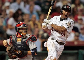 HOUSTON - AUGUST 31:  Michael Bourn #21 of the Houston Astros reacts after fouling a ball off his foot as catcher Yadier Molina #4 of the St. Louis Cardinals watches at Minute Maid Park on August 31, 2010 in Houston, Texas.  (Photo by Bob Levey/Getty Imag