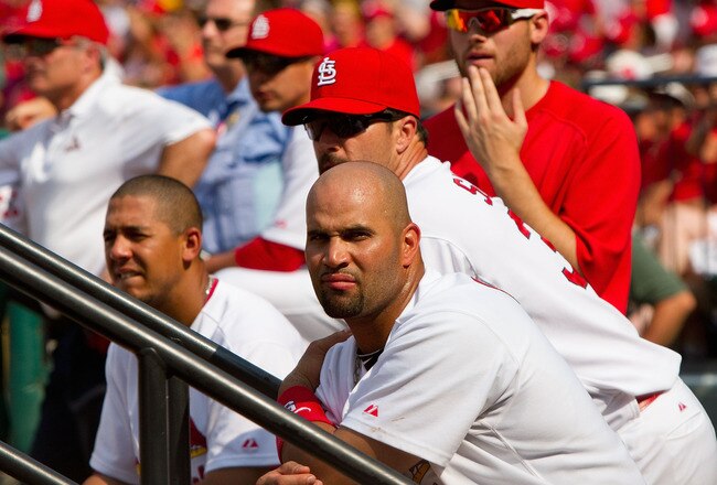 ST. LOUIS - AUGUST 18: Albert Pujols #5 of the St. Louis Cardinals looks on with teammates from the dugout against the Milwaukee Brewers  at Busch Stadium on August 18, 2010 in St. Louis, Missouri.  The Brewers beat the Cardinals 3-2.  (Photo by Dilip Vis