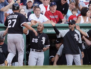 BOSTON - SEPTEMBER 05:  Ramon Castro #27 of the Chicago White Sox is congratulated by Andruw Jones #25 after Castro scored the game winning run on a bases loaded walk in the ninth inning against the Boston Red Sox September 5, 2010 at Fenway Park in Bosto