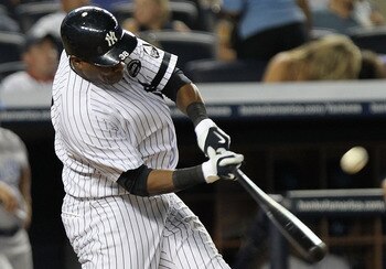 NEW YORK - JULY 22: Marcus Thames #38 of the New York Yankees hits a RBI sacrifice fly to score Jorge Posada #20 against the Kansas City Royals at Yankee Stadium on July 22, 2010 in the Bronx borough of New York City.  (Photo by Nick Laham/Getty Images)