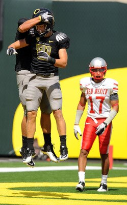EUGENE, OR - SEPTEMBER 04: Wide receiver Justin Hoffman #81 and tight end David Paulson #42 of the Oregon Ducks celebrate a touchdown reception by Paulson in front of safety Freddy Young #17 of the New Mexico Lobos in the first quarter of the game at Autz