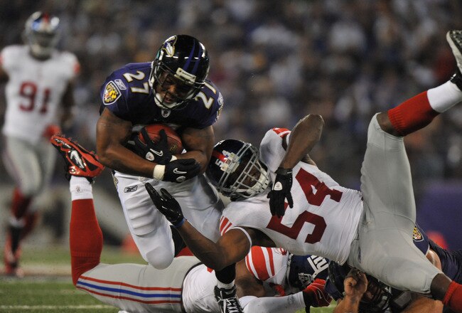 BALTIMORE - AUGUST 28:  Ray Rice #27 of the Baltimore Ravens runs the ball against Jonathan Goff #54 of the New York Giants at M&T Bank Stadium on August 28, 2010 in Baltimore, Maryland. The Ravens lead the Giants 17-3. (Photo by Larry French/Getty Images