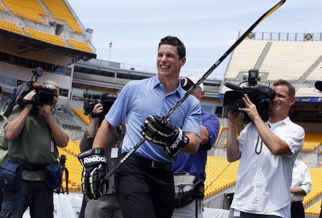 PITTSBURGH - JULY 27:  Sidney Crosby of the Pittsburgh Penguins laughs during a shooting competition at the 2011 Bridgestone NHL Winter Classic press conference on July 27, 2010 at Heinz Field in Pittsburgh, Pennsylvania.  (Photo by Justin K. Aller/Getty