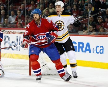 MONTREAL- APRIL 20:  Mathieu Dandenault #25 of the Montreal Canadiens defends against Blake Wheeler #26 of the Boston Bruins during Game Three of the Eastern Conference Quarterfinals of the 2009 Stanley Cup Playoffs at the Bell Centre on April 20, 2009 in