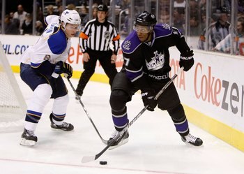 LOS ANGELES, CA - DECEMBER 05:  Erik Johnson #6 of the St. Louis Blues and Wayne Simmonds #17 of the Los Angeles Kings battle for the puck at Staples Center on December 5, 2009 in Los Angeles, California.  (Photo by Jeff Gross/Getty Images)