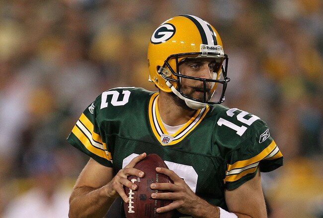 GREEN BAY, WI - AUGUST 26: Aaron Rodgers #12 of the Green Bay Packers looks for a receiver against the Indianapolis Colts during a preseason game at Lambeau Field on August 26, 2010 in Green Bay, Wisconsin. The Packers defeated the Colts 59-24.  (Photo by