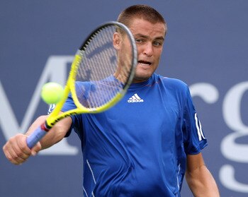 NEW YORK - SEPTEMBER 03:  Mikhail Youzhny of Russia returns a shot against Dudi Sela of Israel during his men's singles match on day five of the 2010 U.S. Open at the USTA Billie Jean King National Tennis Center on September 3, 2010 in the Flushing neighb