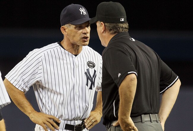 NEW YORK - JULY 20:  Manager Joe Girardi #28 of the New York Yankees argues with first base umpire Paul Emmel during the sixth inning againast the Los Angeles Angels of Anaheim on July 20, 2010 at Yankee Stadium in the Bronx borough of New York City. Gira