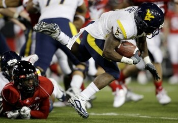 CINCINNATI - NOVEMBER 13:  Runningback Noel Devine #7 of the West Virginia Mountaineers is taken down in the third quarter of the game against the Cincinnati Bearcats in at Nippert Stadium on November 13, 2009 in Cincinnati, Ohio.  (Photo by Andy Lyons/Ge