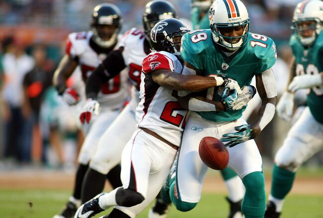 MIAMI - AUGUST 27:  Wide reciever Brandon Marshall #19 of the Miami Dolphins drops the ball  against cornerback Brent Grimes #20 of the Atlanta Falcons during their preseason game at Sun Life Stadium on August 27, 2010 in Miami, Florida.  (Photo by Marc S