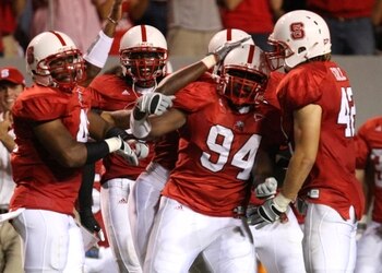 RALEIGH, NC - SEPTEMBER 3:  Grey Berry #94 of the North Carolina State Wolfpack celebrates with his teammates after making an interception against the South Carolina Gamecocks during the game at Carter-Finley Stadium on September 3, 2009 in Raleigh, North