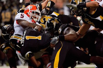 ST. LOUIS - SEPTEMBER 4: Mikel Leshoure #5 of the University of Illinois Fighting Illini is tackled against the University of Missouri Tigers during the State Farm Arch Rivalry game on September 4, 2010 at the Edward Jones Dome in St. Louis, Missouri. The