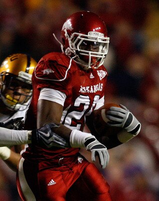 BATON ROUGE, LA - NOVEMBER 28:  Ronnie Wingo Jr. #20 of the Arkansas Razorbacks avoids a tackle by Harry Coleman #24 and Rahim Alem #84 of the LSU Tigers at Tiger Stadium on November 28, 2009 in Baton Rouge, Louisiana.  The Tigers defeated the Razorbacks