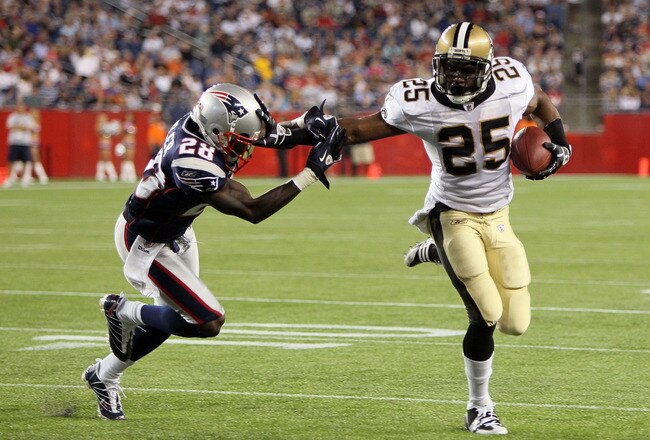 FOXBORO, MA - AUGUST 12: Reggie Bush # 25 of the New Orleans Saints scores a touchdown against the defense of Darius Butler # 28 of the New England Patriots during the preseason game against the New England Patriots at Gillette Stadium on August 12, 2010 