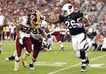 GLENDALE, AZ - SEPTEMBER 02:  Runningback Beanie Wells #26 of the Arizona Cardinals rushes the football against Chris Wilson #95 and Kevin Barnes #25 of the Washington Redskins during the first quarter of the preseason NFL game at the University of Phoeni