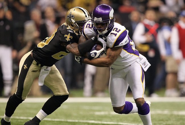NEW ORLEANS - JANUARY 24:  Percy Harvin #12 of the Minnesota Vikings returns a punt against Randall Gay #20 of the New Orleans Saints during the NFC Championship Game at the Louisiana Superdome on January 24, 2010 in New Orleans, Louisiana. The Saints won