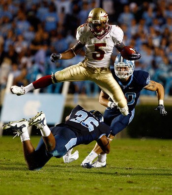 CHAPEL HILL, NC - OCTOBER 22:  Greg Reid #5 of the Florida State Seminoles leaps over North Carolina Tar Heels defenders Kennedy Tinsley #36 and Hunter Furr, #40 at Kenan Stadium on October 22, 2009 in Chapel Hill, North Carolina.  (Photo by Scott Hallera