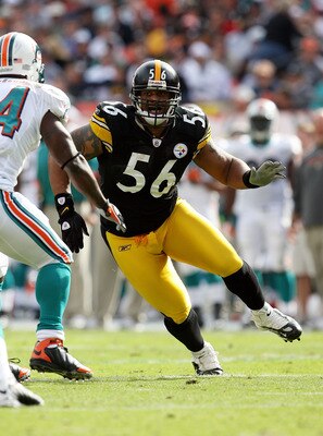 MIAMI - JANUARY 03:  Linebacker LaMarr Woodley #56 of the Pittsburgh Steelers tries to get into the backfield around running back Ricky Williams #34 of the Miami Dolphins at Land Shark Stadium on January 3, 2010 in Miami, Florida. The Steelers defeated th